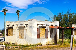 Abandoned Stucco Building With Boarded Up Windows