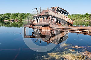 Abandoned sunken Barges Boats On River Pripyat in Chernobyl exclusion Zone. Chernobyl Nuclear Power Plant Zone of Alienation in