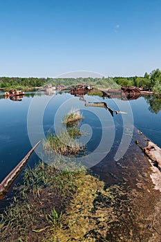 Abandoned sunken Barges Boats On River Pripyat in Chernobyl exclusion Zone. Chernobyl Nuclear Power Plant Zone of Alienation in