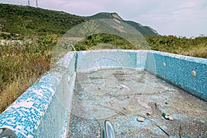 Abandoned swimming pool with mountain background