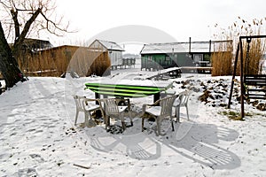 Abandoned table with chairs in winter at the famous floating village Bokod,Hungary