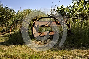 Abandoned thresher in the italian countryside at sunset in summer