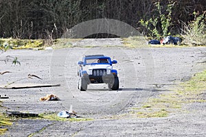 Abandoned toy car on waste and rubbish dump site