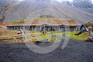 Abandoned traditional houses in Viking village against Vestrahorn mountain