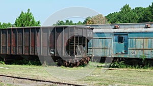 Abandoned train boxcars and hopper