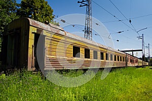 Abandoned train. Forgotten overgrown railway. Old rusty railway carriage