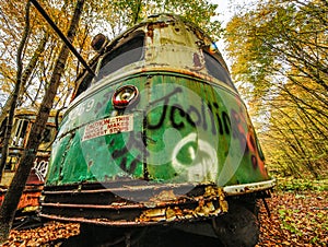 Abandoned Trolley Car in Woods in Fall with Caution Sign