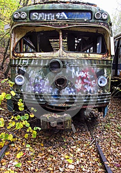 Abandoned trolley cars head on view on rails