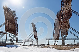 Abandoned troposphere station. Woman and huge tropospheric communication antennas.