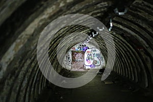 Abandoned tunnel bunker, partially illuminated by a flashlight