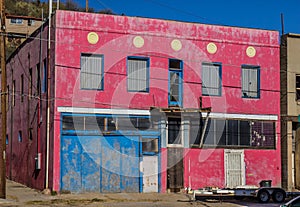 Abandoned Two Story Building With Boarded Up Doors