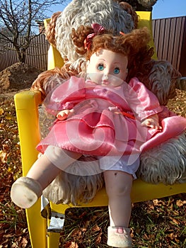 Abandoned unnecessary doll in a beautiful pink dress