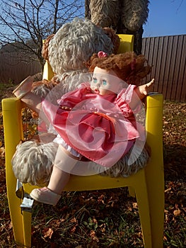 Abandoned unnecessary doll in a beautiful pink dress