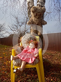 Abandoned unnecessary doll in a beautiful pink dress