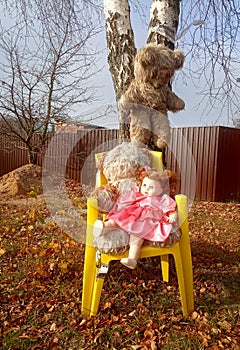 Abandoned unnecessary doll in a beautiful pink dress