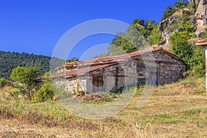 Abandoned village house with bricks walls and an red-tiled roof