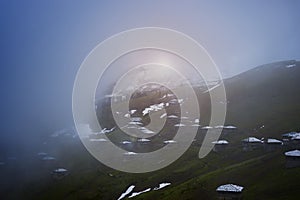 Abandoned village of shepherds in fog after storm