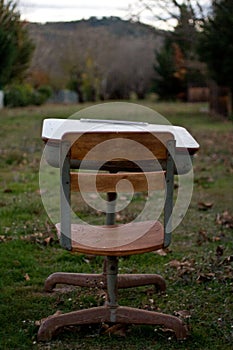 Abandoned Vintage Schooldesk in Field