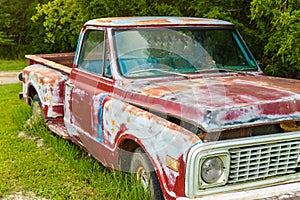 Abandoned Vintage truck parked in a field on a farm