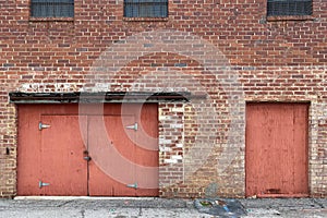 Abandoned warehouse alley brick wall red doors