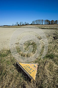 Abandoned warning sign for moose hunting next to the field in countryside near Vasteras, Sweden