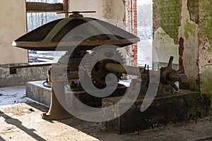 Abandoned water mill. Rusty iron wheel natural background.