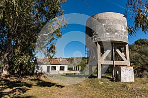 Abandoned water tank and house next to the train station at its stop next to the Tagus, near Garrovillas