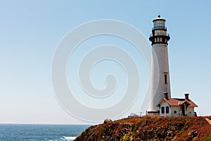 Abandoned and weathered lighthouse stands on California Pacific Ocean coast