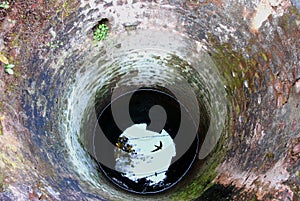 An abandoned well made by bricks