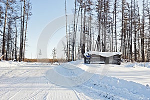 Abandoned winter hut on winter forest road