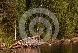 Abandoned wooden boat by the river