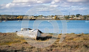 Abandoned wooden boat on the shore of the river