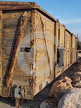 Abandoned wooden railway car on props