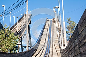 Abandoned wooden ski jumping hill on blue sky background in Kouvola, Finland