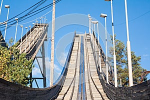 Abandoned wooden ski jumping hill on blue sky background in Kouvola, Finland