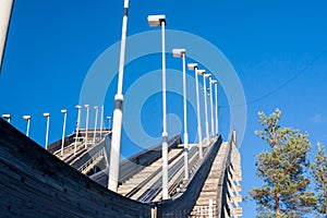 Abandoned wooden ski jumping hill on blue sky background in Kouvola, Finland