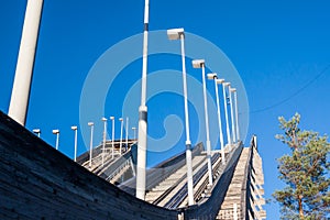 Abandoned wooden ski jumping hill on blue sky background in Kouvola, Finland