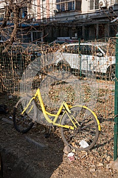 Abandoned Xiao Huang ofo bike sharing in a dirty corner