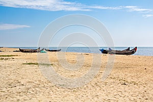 Abandonned artistic wooden canoe on a lonely beach