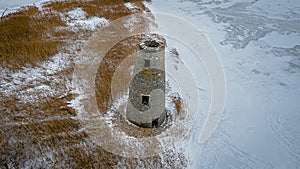 An abanoned ruined lighthouse in winter