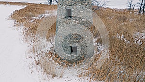 An abanoned ruined lighthouse in winter