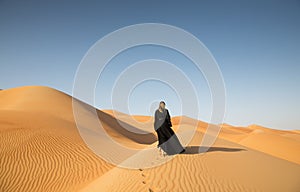 With Abaya in sandunes photo