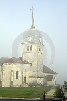 Abbey church in Jura, France and cure house of the priest.