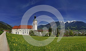Abbey in Fiecht, Tyrol, Austria. View to abbey and church with alps in the background.
