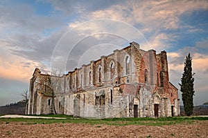 Abbey of Saint Galgano in Chiusdino, Siena, Tuscany, Italy. View at sunset of the medieval roofless church in ruins