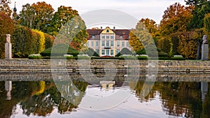 Abbots Palace in the rococo style and located in Oliwa Park in autumn scenery.