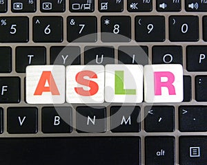 Abbreviation ASLR on keyboard background photo