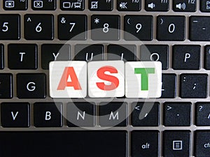 Abbreviation AST on keyboard background photo