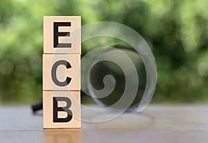 The abbreviation of the ECB is the central bank of the European Union and the euro area. On wooden cubes on a table with a