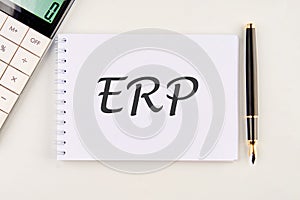 Abbreviation ERP - Enterprise Resource Planning on a white notebook